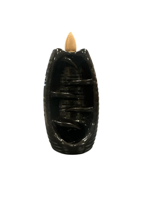 Black incense burner with a wooden incense stick on a white background