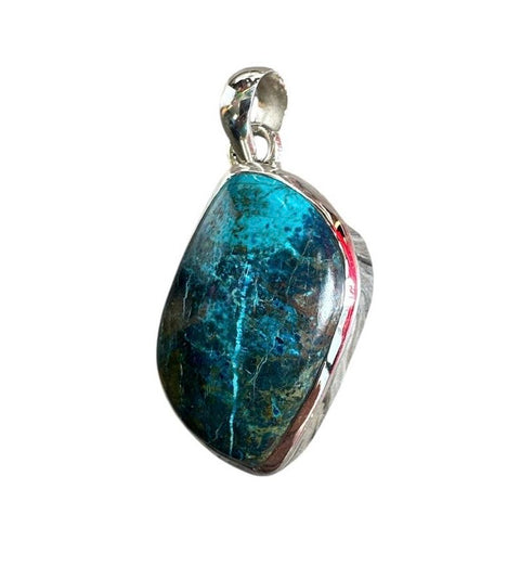 Blue stone pendant with silver setting on a white background
