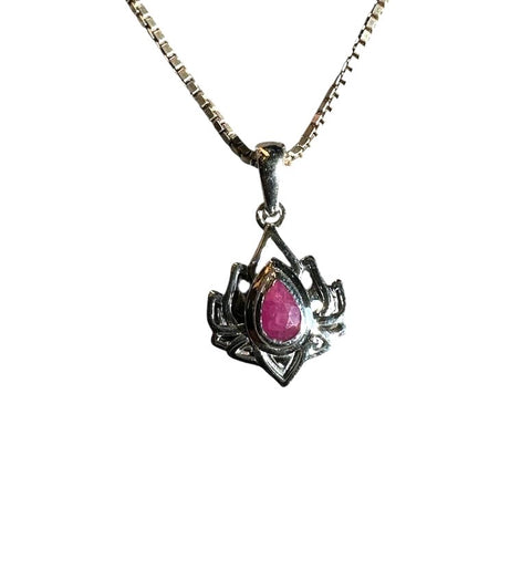 Spider-shaped pendant with a pink gemstone on a white background