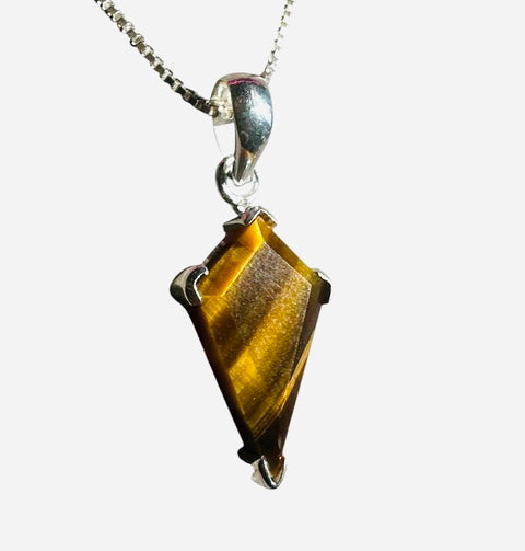 Tiger's eye pendant on a silver chain against a white background