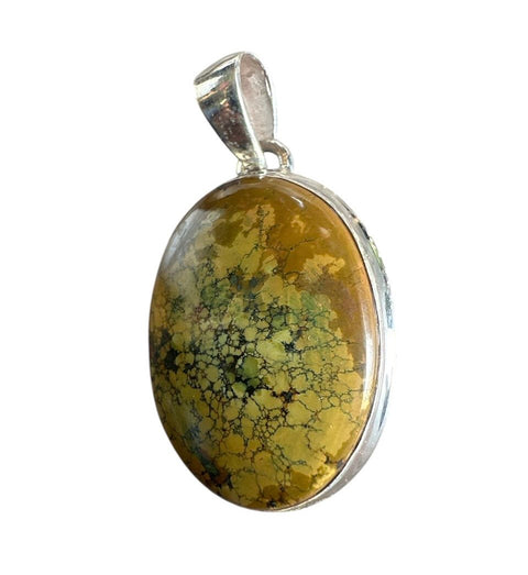 Pendant with a yellow and black marbled stone on a white background