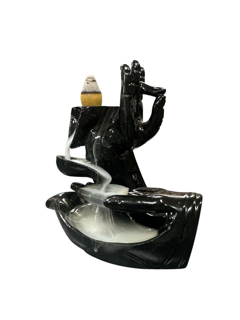 Black incense burner with smoke on a white background