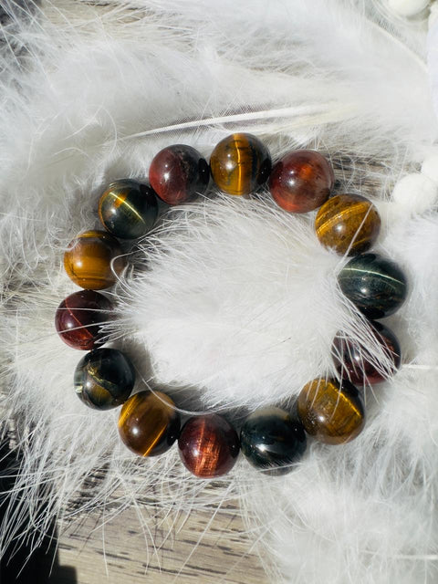 Multicolored beaded bracelet on a white feather background